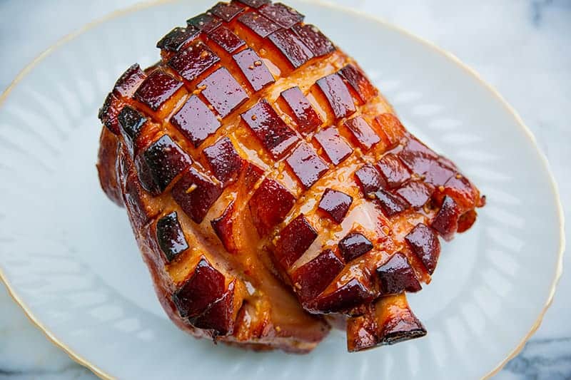 Brown Sugar Glazed Baked Picnic Ham in a gold line serving plate