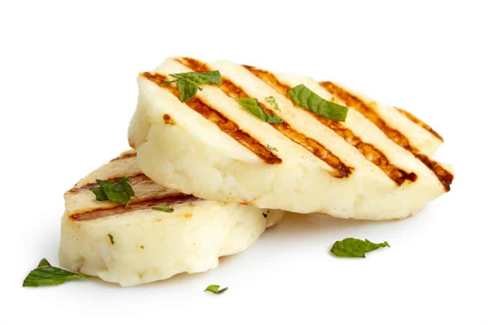 Grilled slabs of Halloumi Cheese on white background