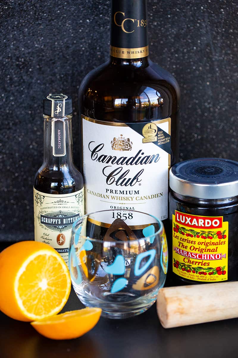 the Old Fashioned Ingredients: Canadian Club whiskey, Luxardo cherries, Scrappy's bitters and an orange.