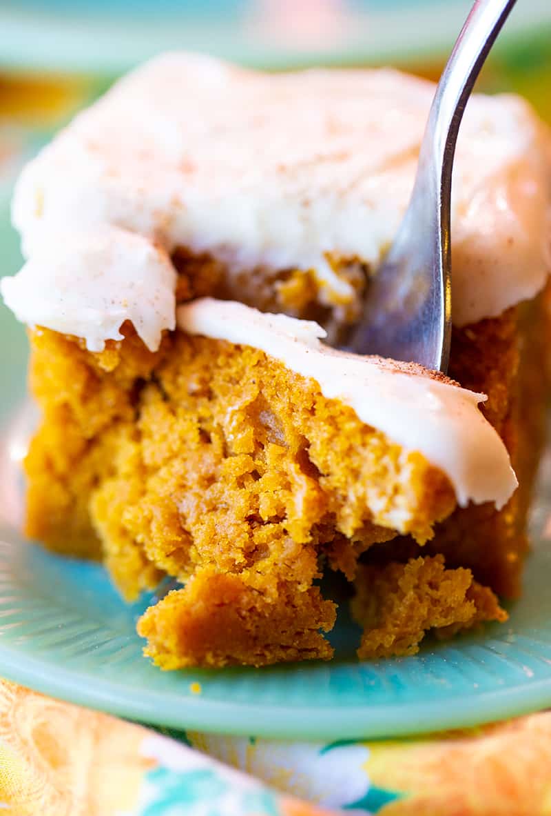 using a fork to get a piece of Pumpkin Bar with Cream Cheese Frosting