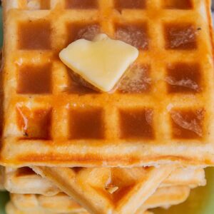 close up stack of waffle with Brown sugar syrup and butter