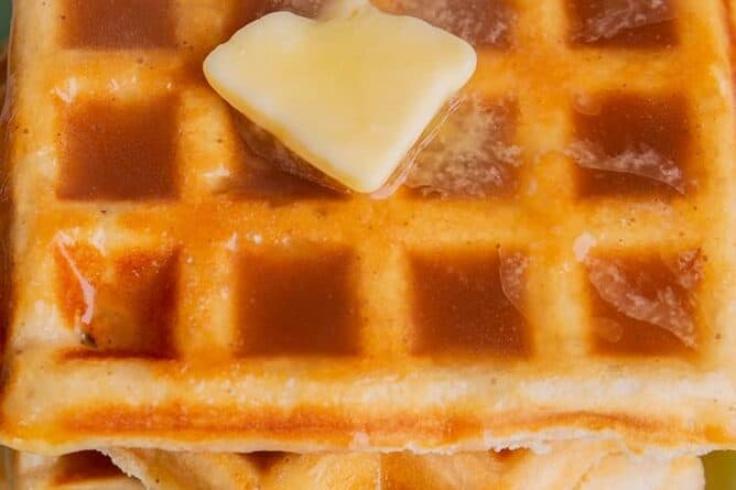close up stack of waffle with Brown sugar syrup and butter