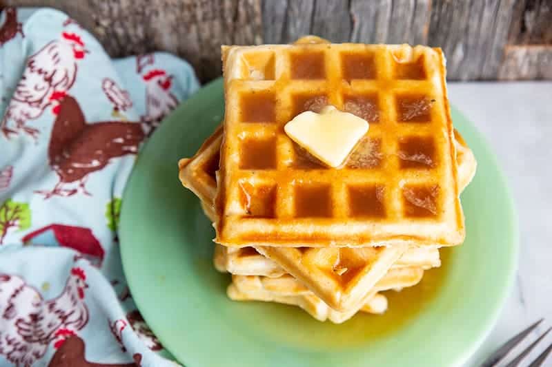 Brown Sugar Syrup on a stack of waffle with butter in a green plate