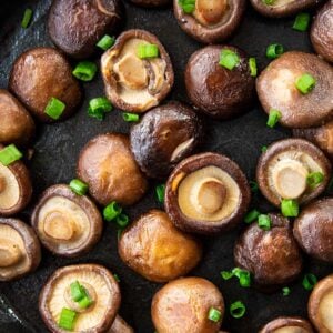 close up skillet with Shiitake Mushrooms garnish with green onions