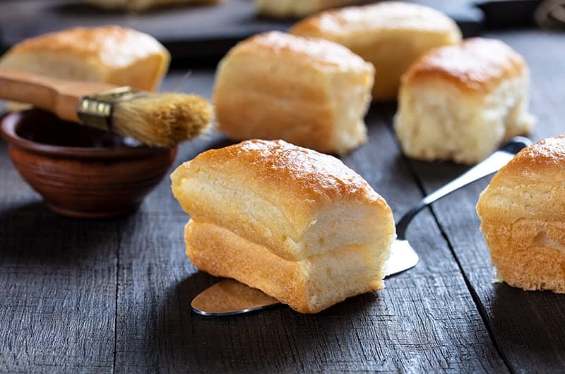 soft buttery delicious Parker House Rolls on a wooden background