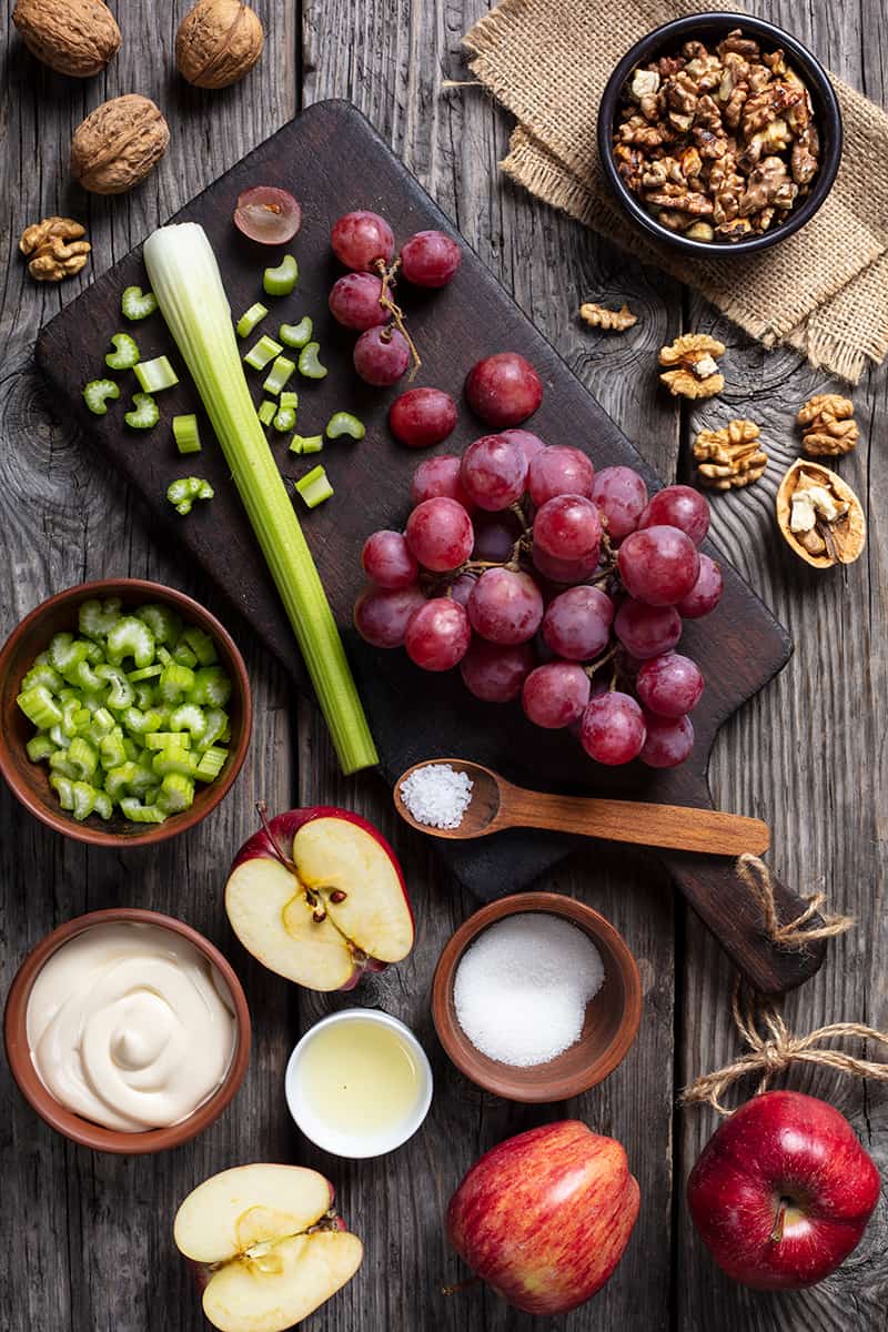 Classic Waldorf Salad ingredients on wood background