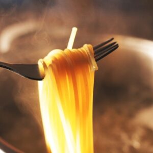 Cooking Pasta to Al Dente, close up cooked paste in a fork