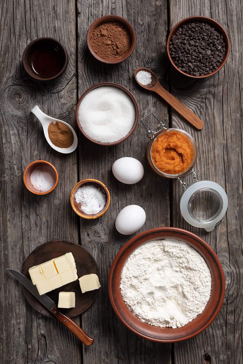 ingredients for pumpkin muffins on a large wooden board