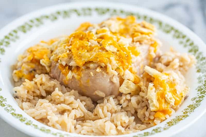 white bowl with tender pork chops and rice baked in a delicious mushroom soup sauce