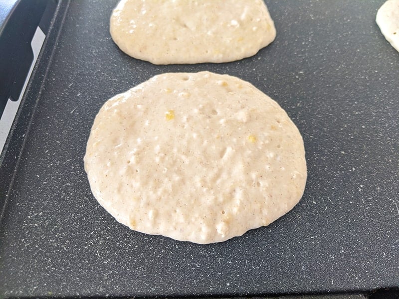 scoops of pancake batter on a griddle