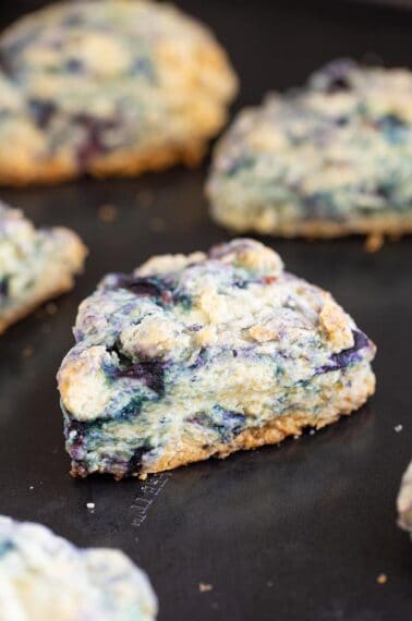 close up buttery blueberry scone on a baking sheet