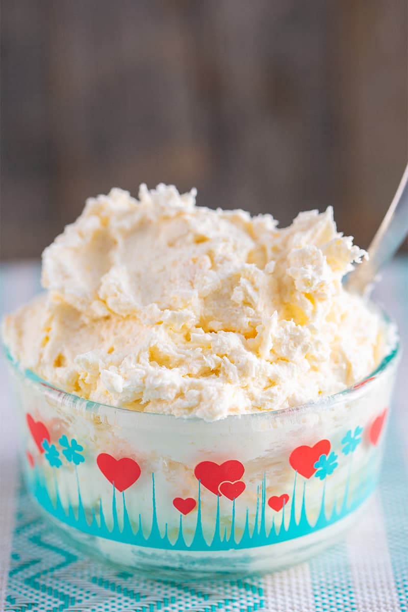 close up clotted cream in a heart patterned Pyrex container