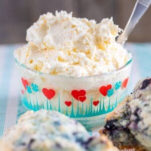 clotted cream in a heart patterned Pyrex container and blueberry scones