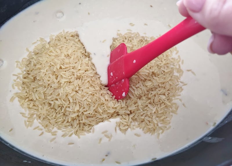 rice, soup, water and soup mix whisk together using a red spatula