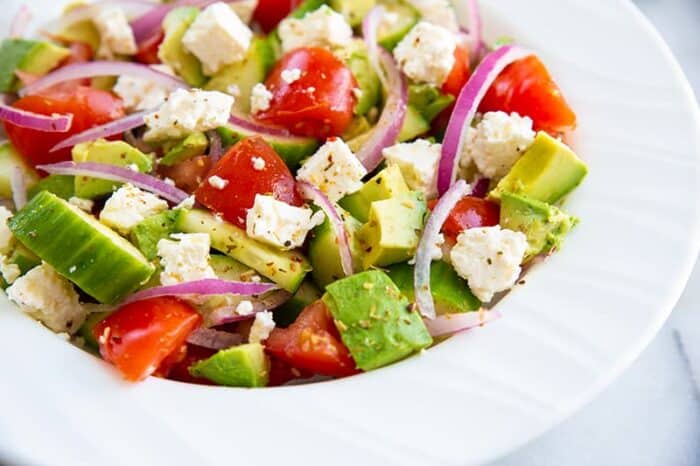 close up of avocado salad in white bowl