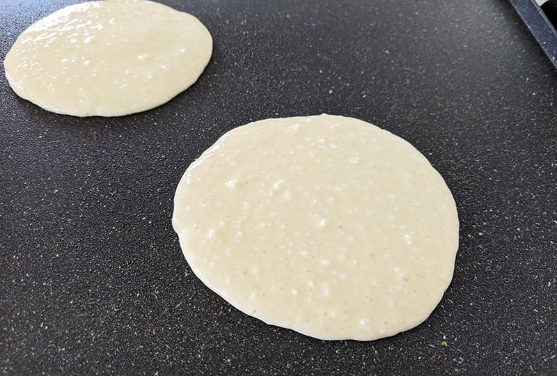 scooped cottage cheese pancake batters cooking on the griddle