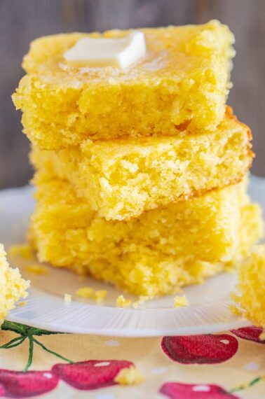 a stack of Jiffy cornbread slices with melting butter on top