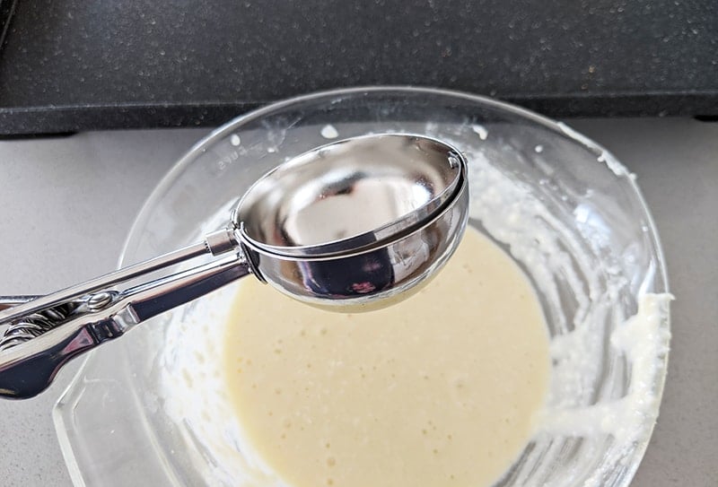 a stainless steel disher use in scooping cottage cheese pancake batter