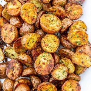 roasted red potatoes on a white serving dish