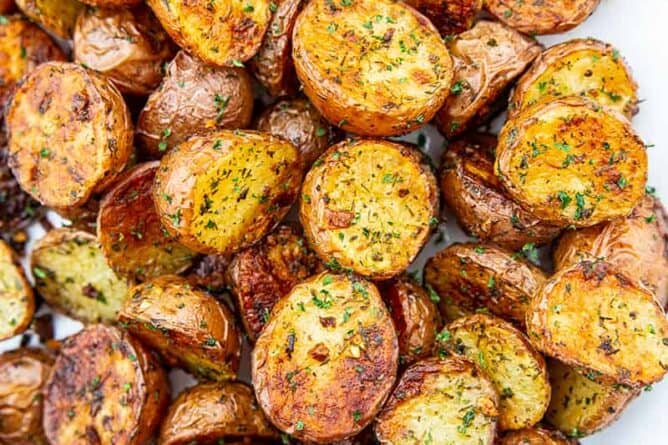 roasted red potatoes on a white serving dish
