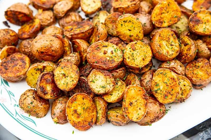 roasted red potatoes on a white serving dish