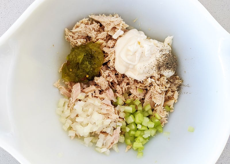 all the tuna filling ingredients on a white bowl