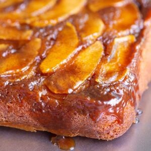 apple upside down cake with caramel dripping down the corner