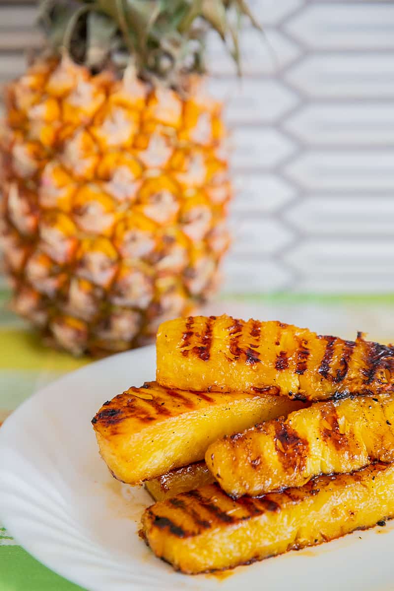 Grilled Pineapple slices on a while plate