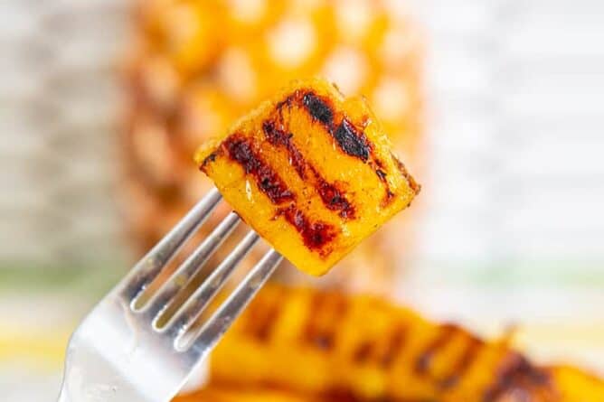 fork holding a piece of Grilled Pineapple slice