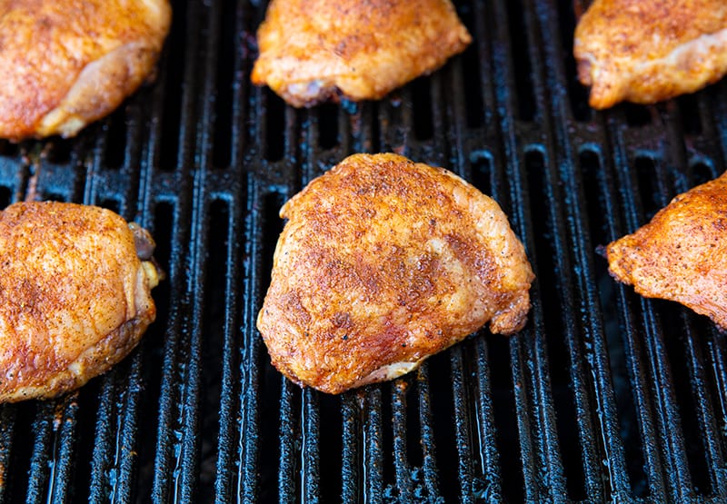 6 grilled chicken thighs on the barbecue 