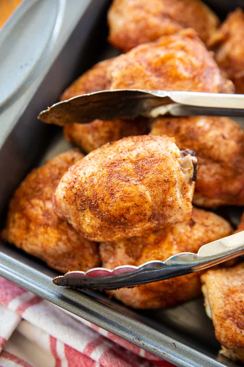 grilled chicken thighs in a baking pan for serving