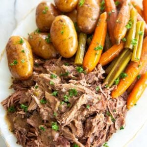 pot roast on a white plate with vegetables