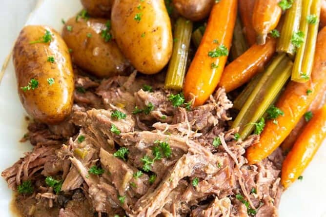 pot roast on a white plate with vegetables