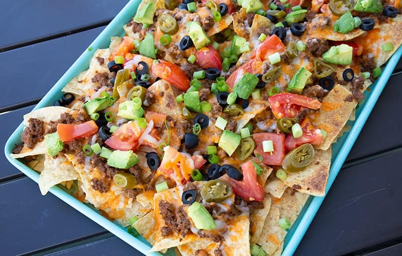 Taco Sheet Pan Nachos on a turquoise cookie sheet