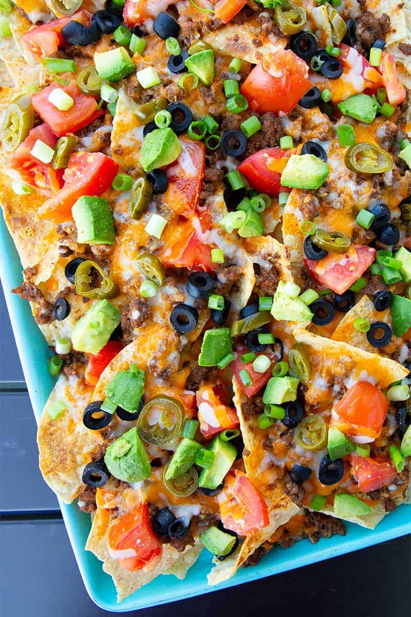 close up of Taco Sheet Pan Nachos on a turquoise cookie sheet