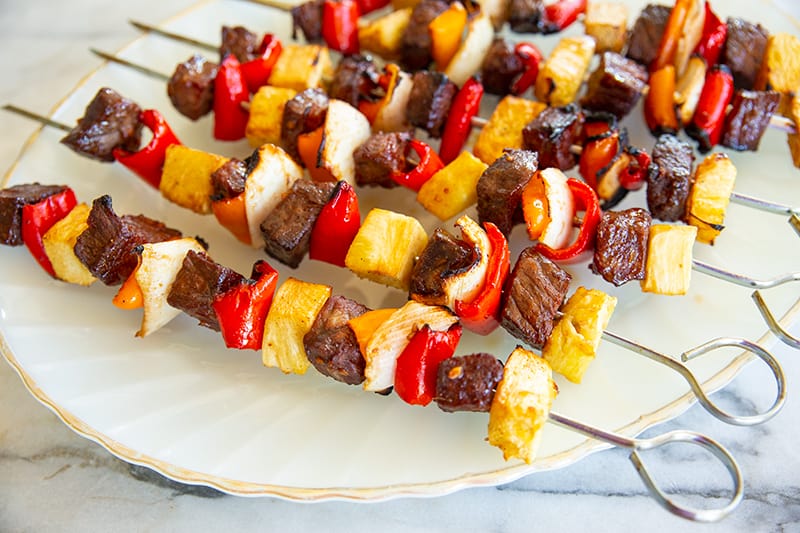  beef kabobs on a white plate