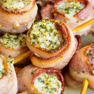 close up pieces of Bacon Wrapped Scallops in small bamboo skewer