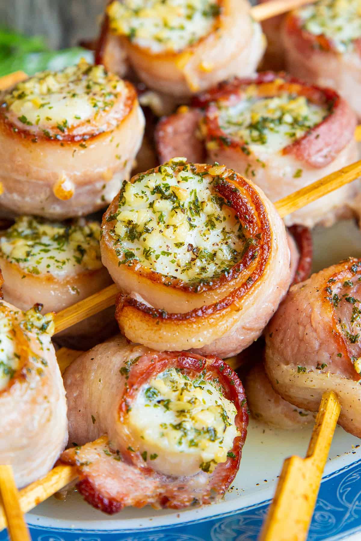 close up pieces of Bacon Wrapped Scallops in small bamboo skewer