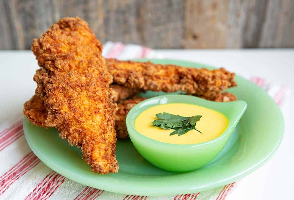 Fried Chicken Strips in green jadeite serving dish with the dipping sauce on the side