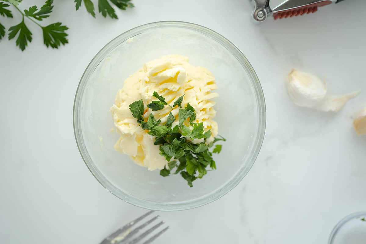 Ingredients for Garlic Butter in a clear bowl