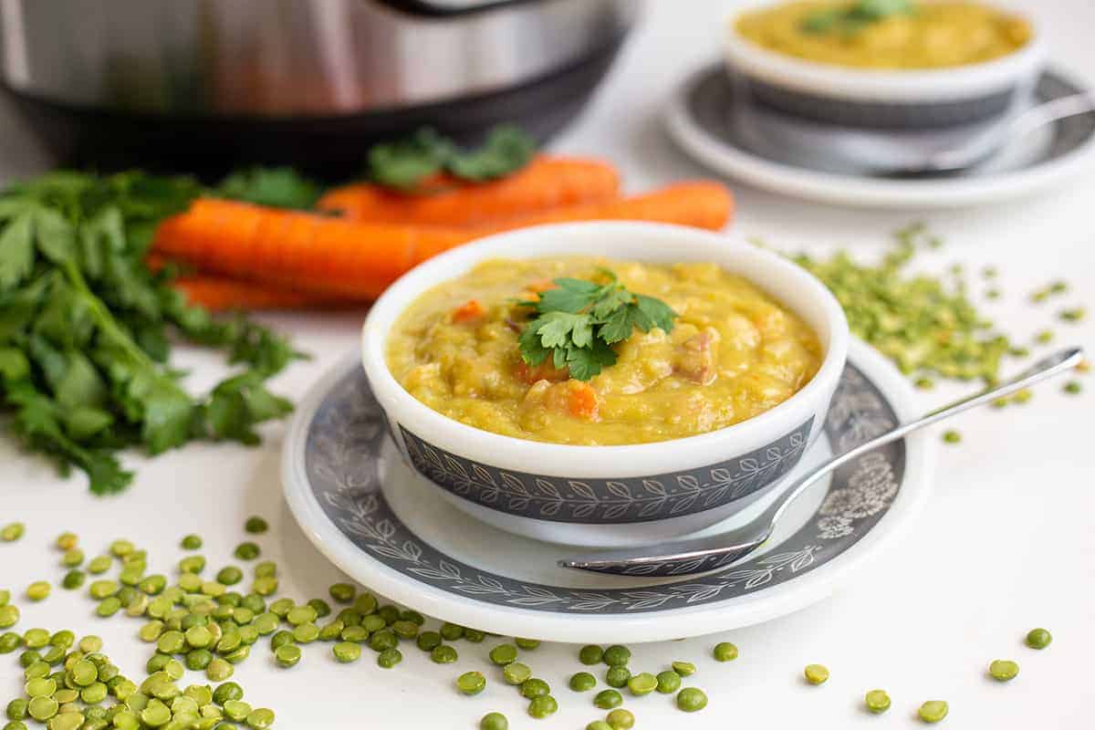 split pea soup in a white bowl with an Instant Pot in the background 