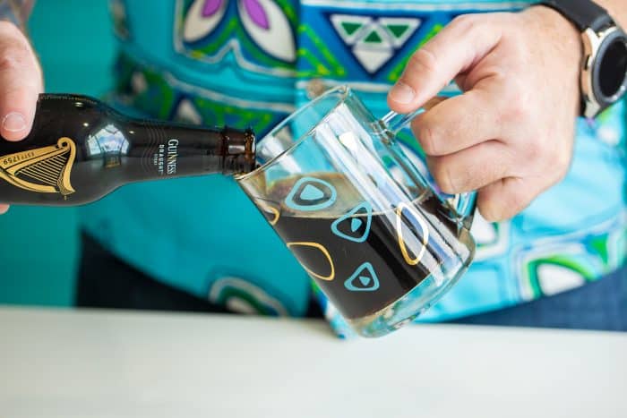 pouring stout (beer) into a beer mug