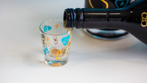Pouring Irish cream into a shot glass