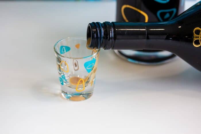 Pouring Irish cream into a shot glass