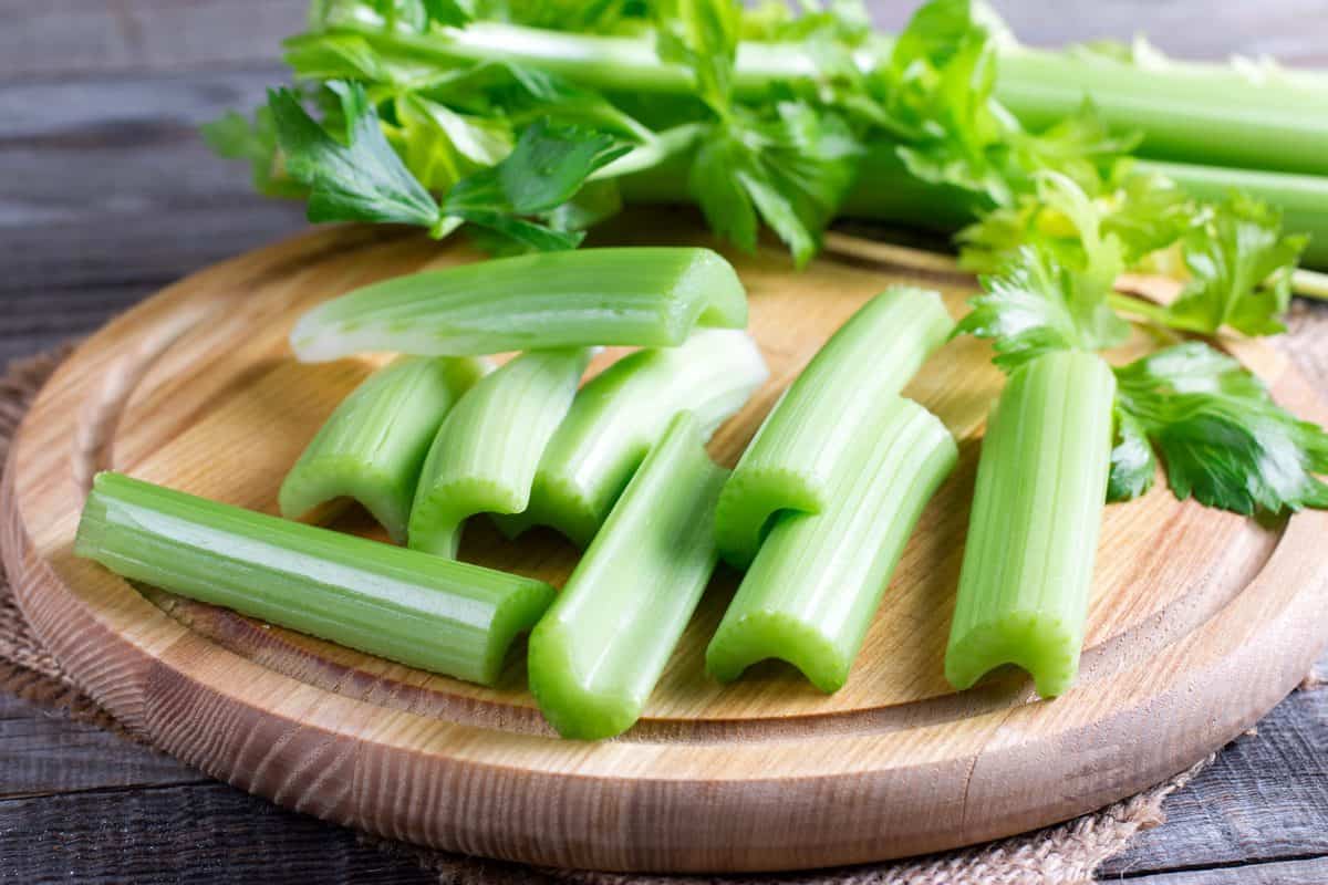 Celery on a wood cutting board.