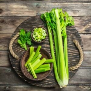 Celery on a wood cutting board.