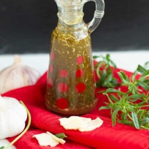 close up oil and vinegar based Italian Dressing in a transparent container
