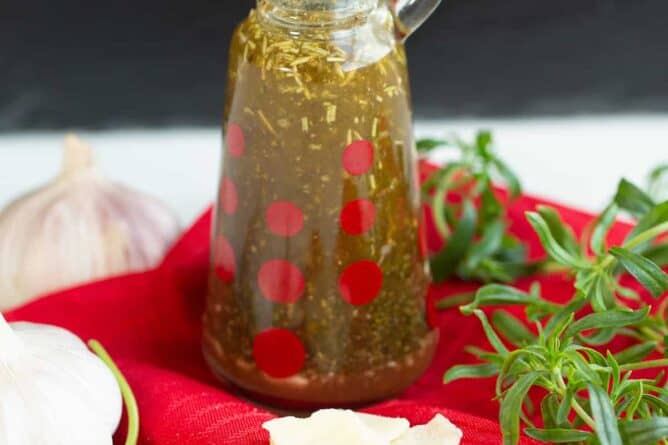 close up oil and vinegar based Italian Dressing in a transparent container