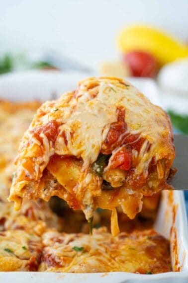 vegetable lasagna slice being removed from pan