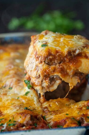 Beef Lasagna being lifted from a pan